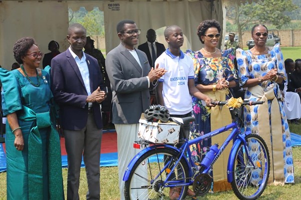  Student Newton Kasasa was presented with a bicycle as a gift for being the best student