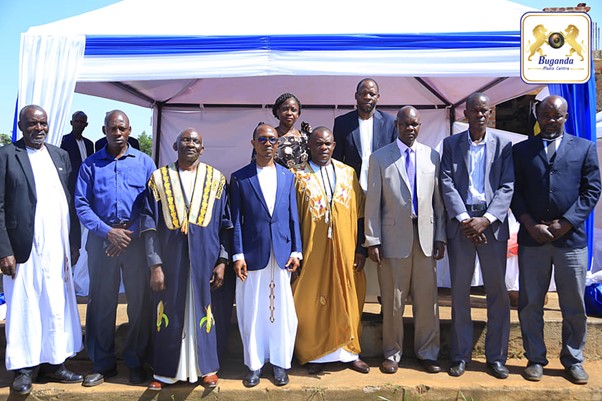 Minister Hon. Joseph Kawuuki was posing for a group photo with the new Kabaka representative and his team